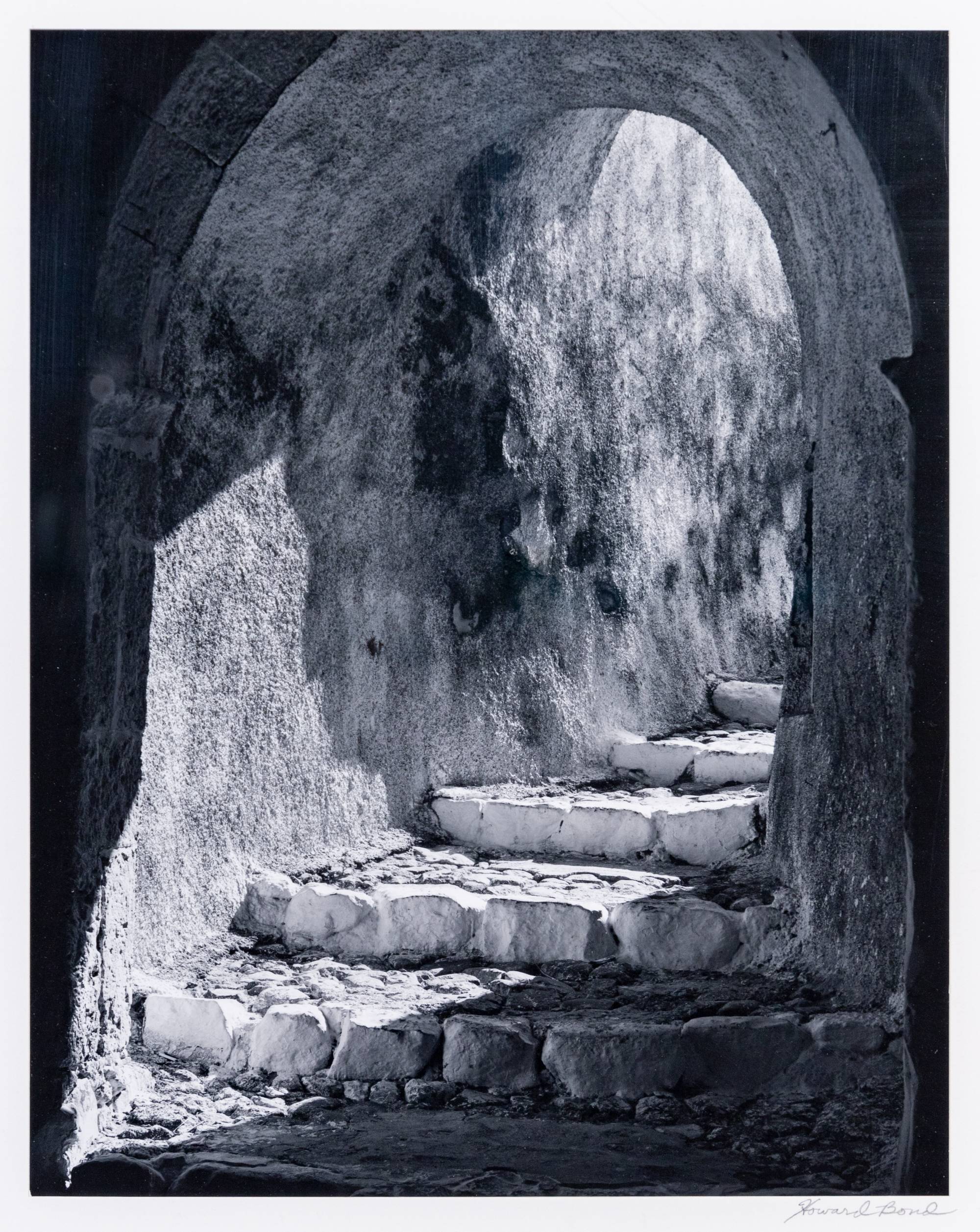 arched passage way containing stone steps